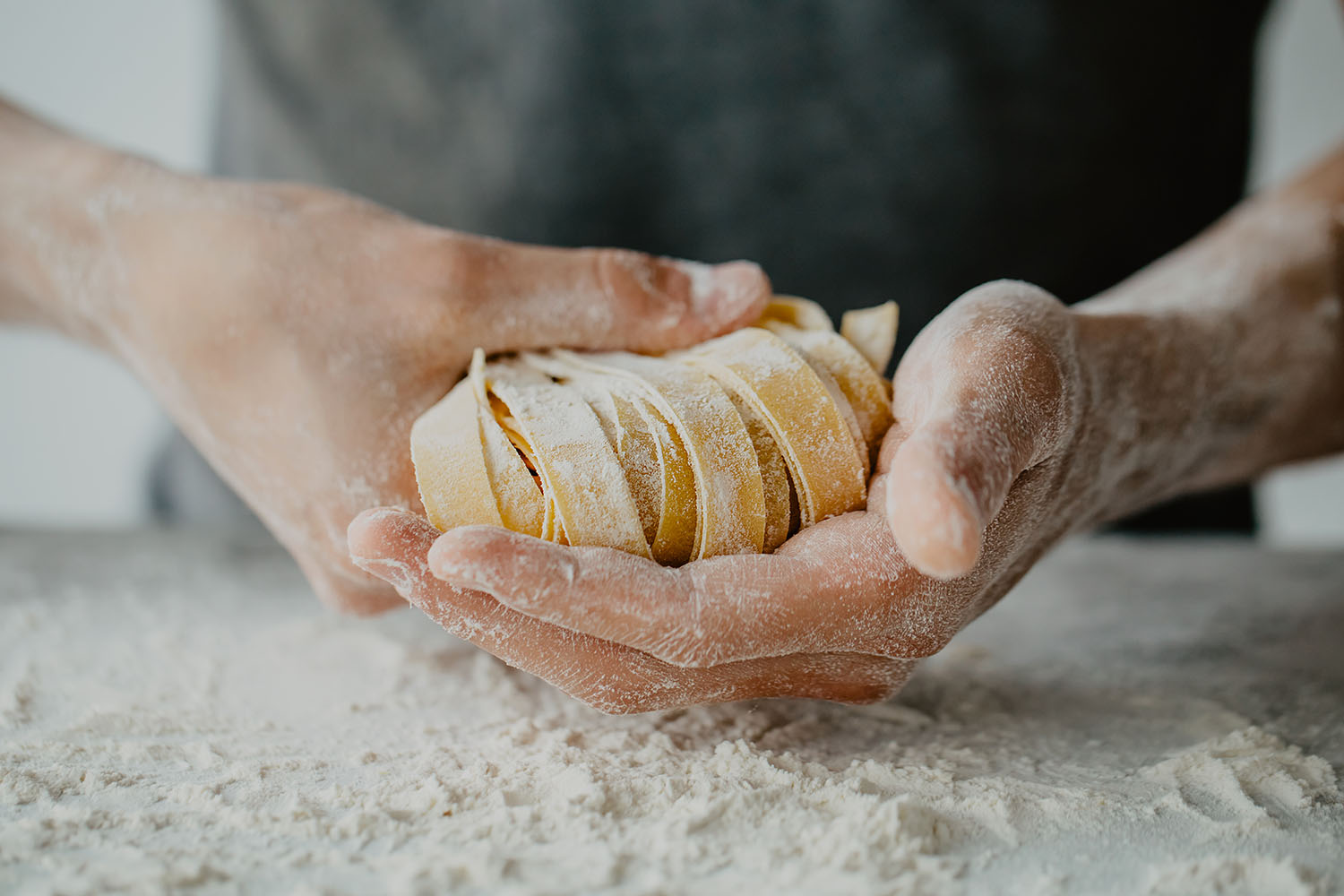 Closeup of process of making cooking homemade pasta. Chef make fresh italian traditional pasta